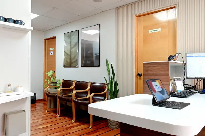 Sala de espera con sillones junto al mesón de recepción